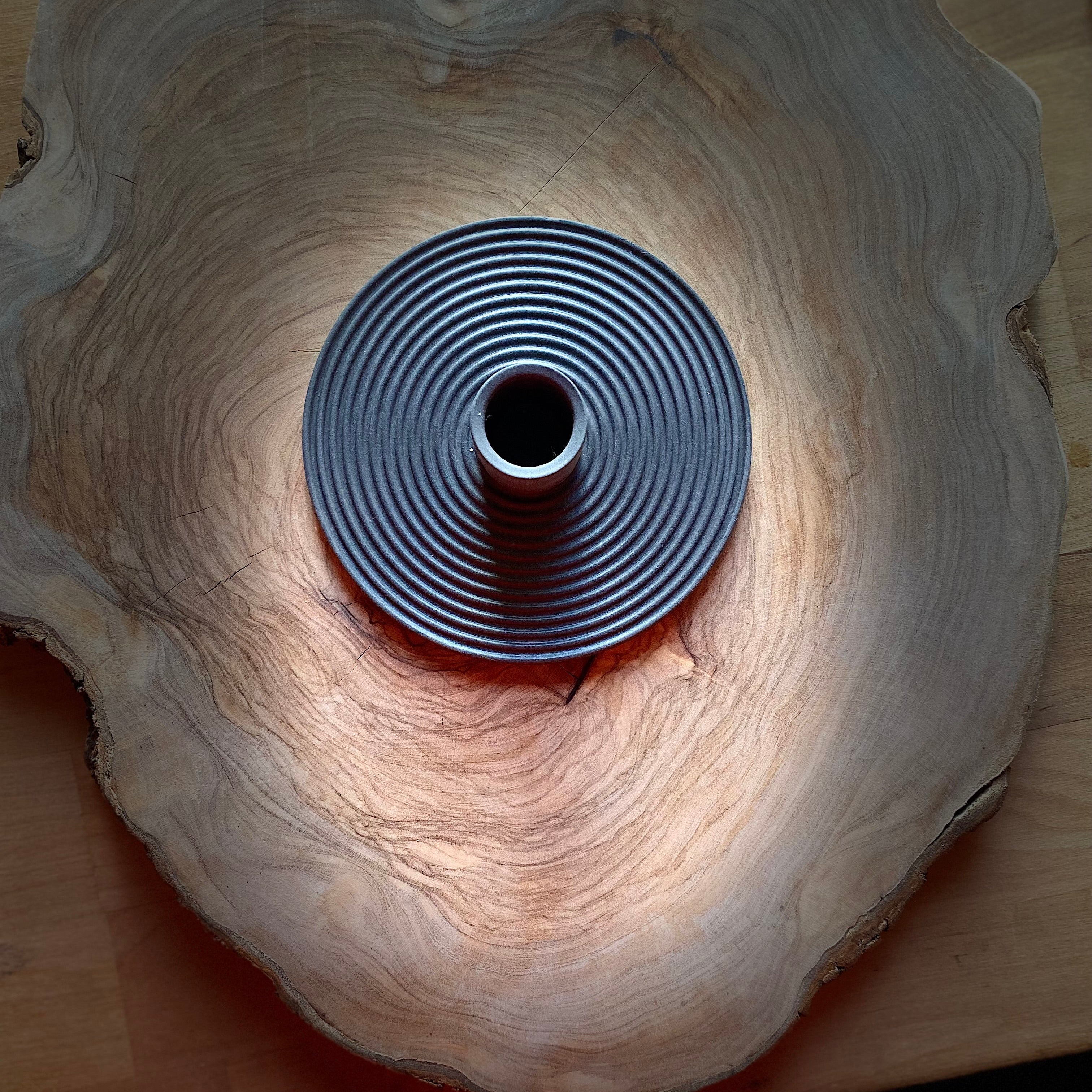 Ceramic nordic charcoal black candle holder on a wooden board