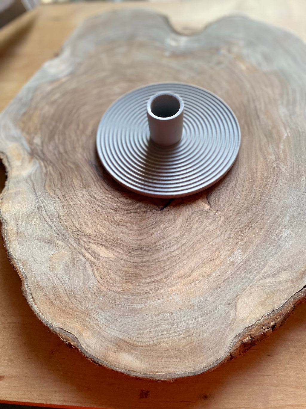 Ceramic candle holder on a wooden surface